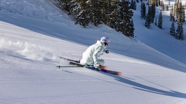 Skier skiing on a groomed slope