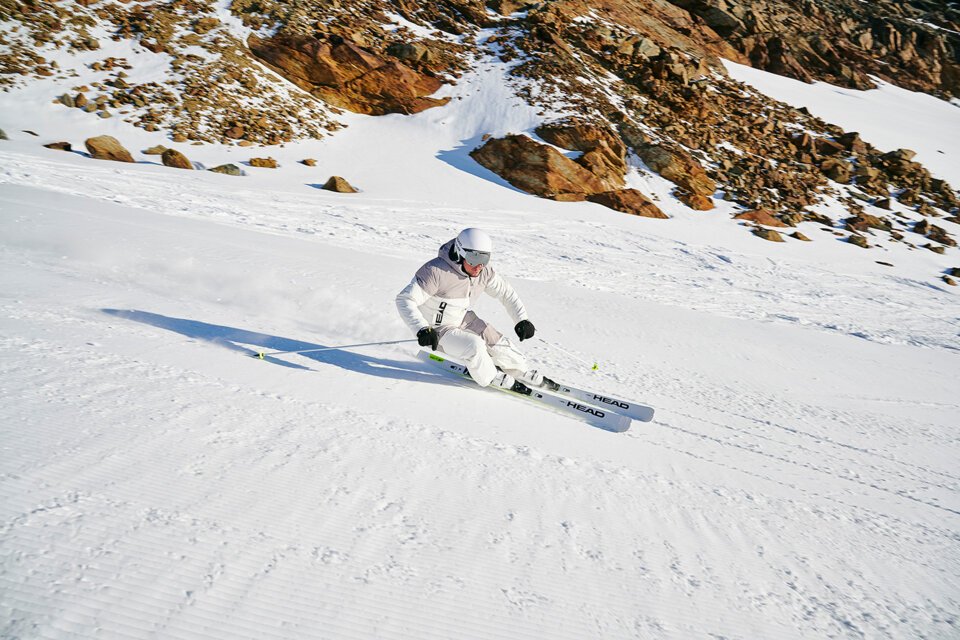 Skifahrer fährt auf einer schneebedeckten Piste.