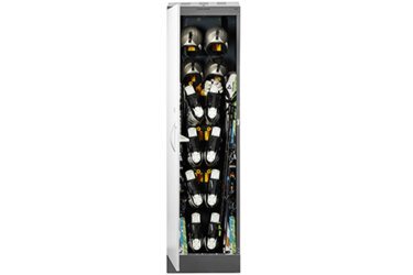 Ski locker with ski boots, helmets, and skis.