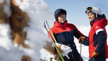 Two skiiers talking with each other